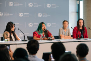 Xananine on stage with Greta Thunberg in Bonn Climate Change Conference